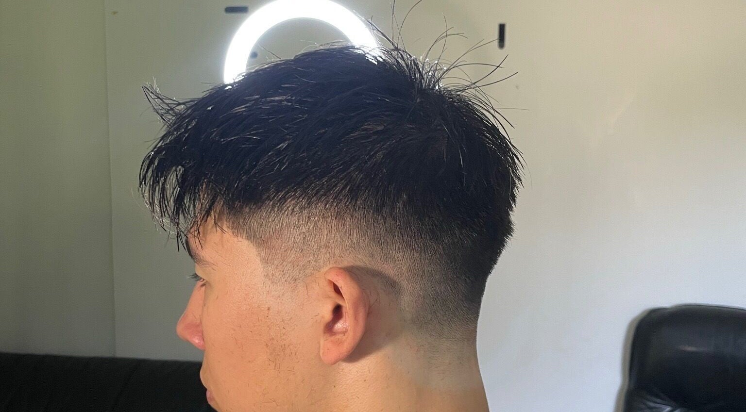 Close-up of a sleek fade hairstyle at D.A Cutz, Halifax, Nova Scotia, CA under professional lighting.