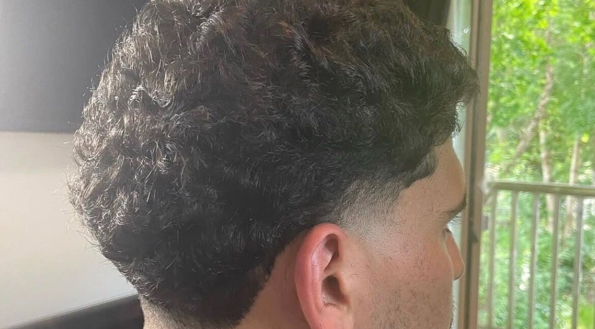 Fresh curly fade at D.A Cutz in Halifax, Nova Scotia, CA highlighting expert styling.