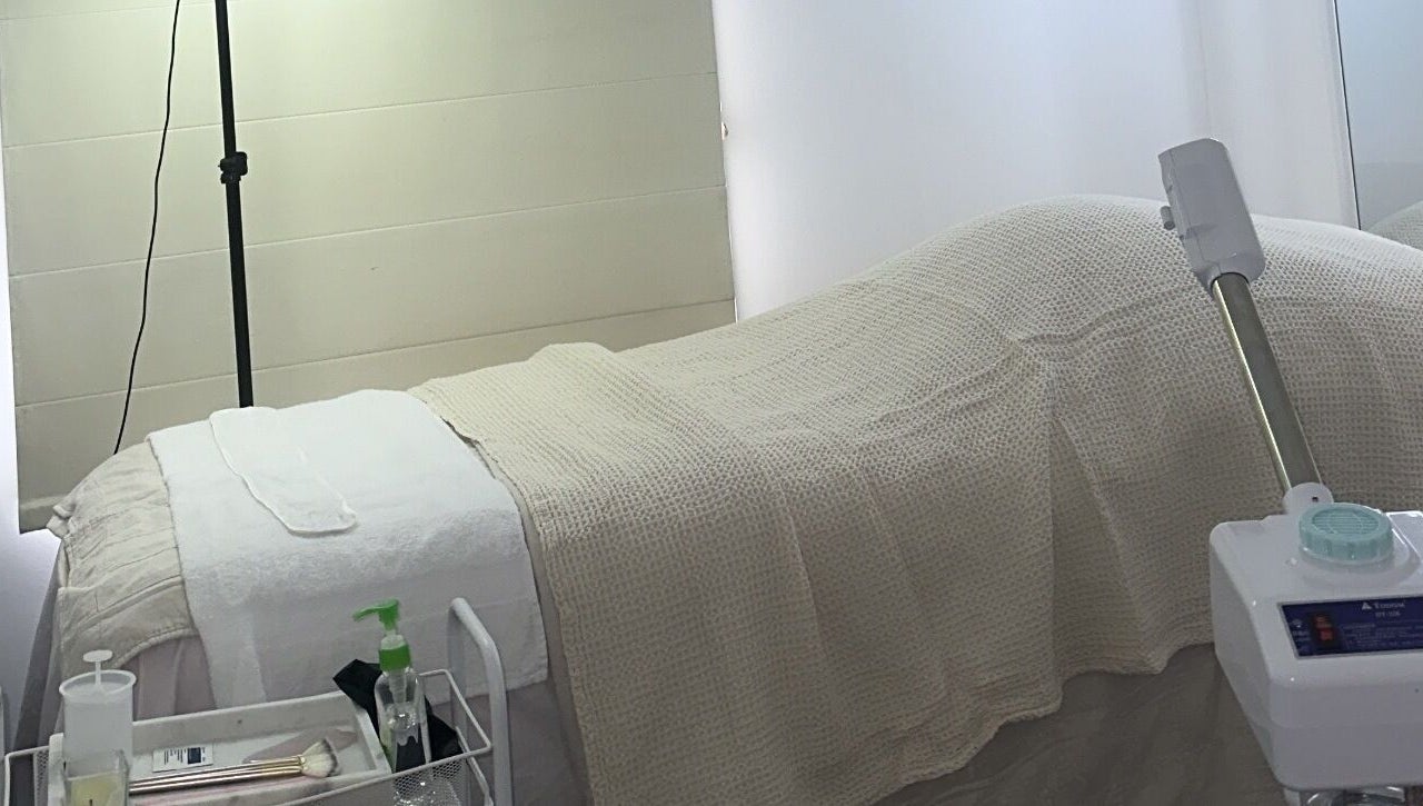 Relaxing treatment room at Glowy With B, Melbourne, Victoria, AU, featuring a cozy bed and spa equipment.
