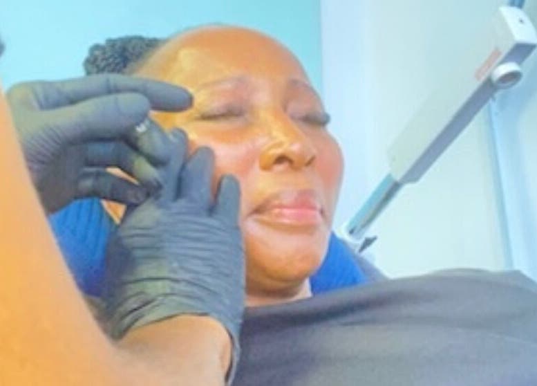 Facial treatment at DK HARMONY WELLNESS & MEDSPA, Johannesburg, Gauteng, ZA. Client enjoys soothing skincare service.