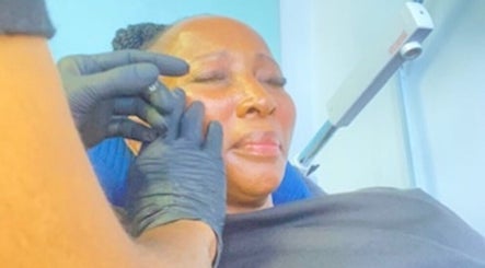 Facial treatment at DK HARMONY WELLNESS & MEDSPA, Johannesburg, Gauteng, ZA. Client enjoys soothing skincare service.