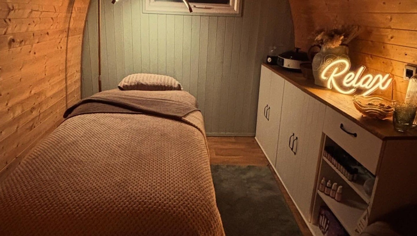 Tranquil massage room at Rhilax, Ilkeston, England, GB, with a comfy bed and ambient lighting.