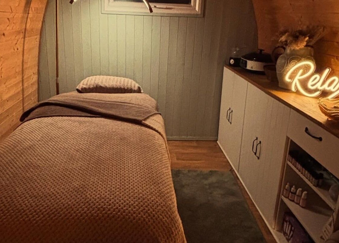 Tranquil massage room at Rhilax, Ilkeston, England, GB, with a comfy bed and ambient lighting.