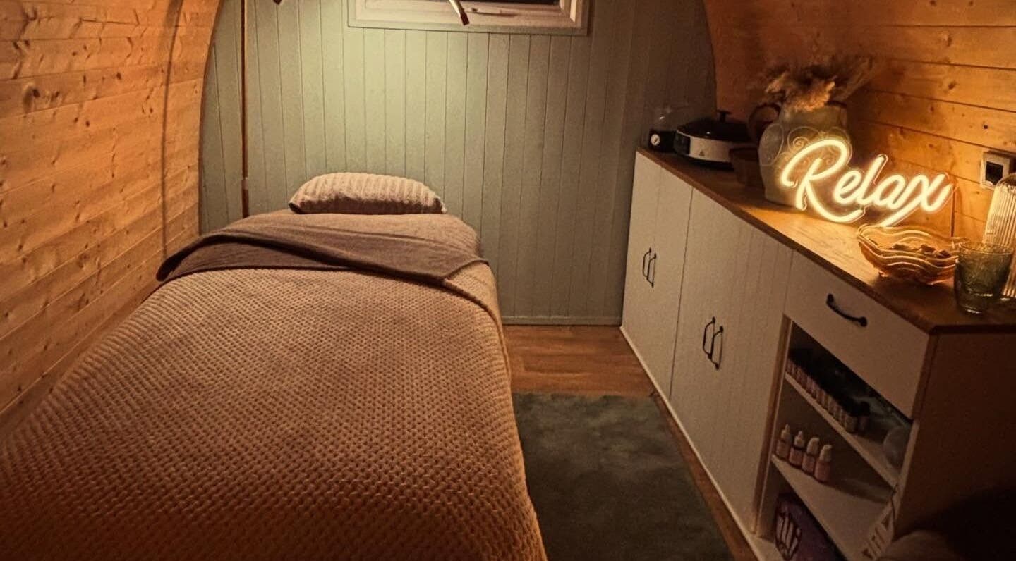 Tranquil massage room at Rhilax, Ilkeston, England, GB, with a comfy bed and ambient lighting.