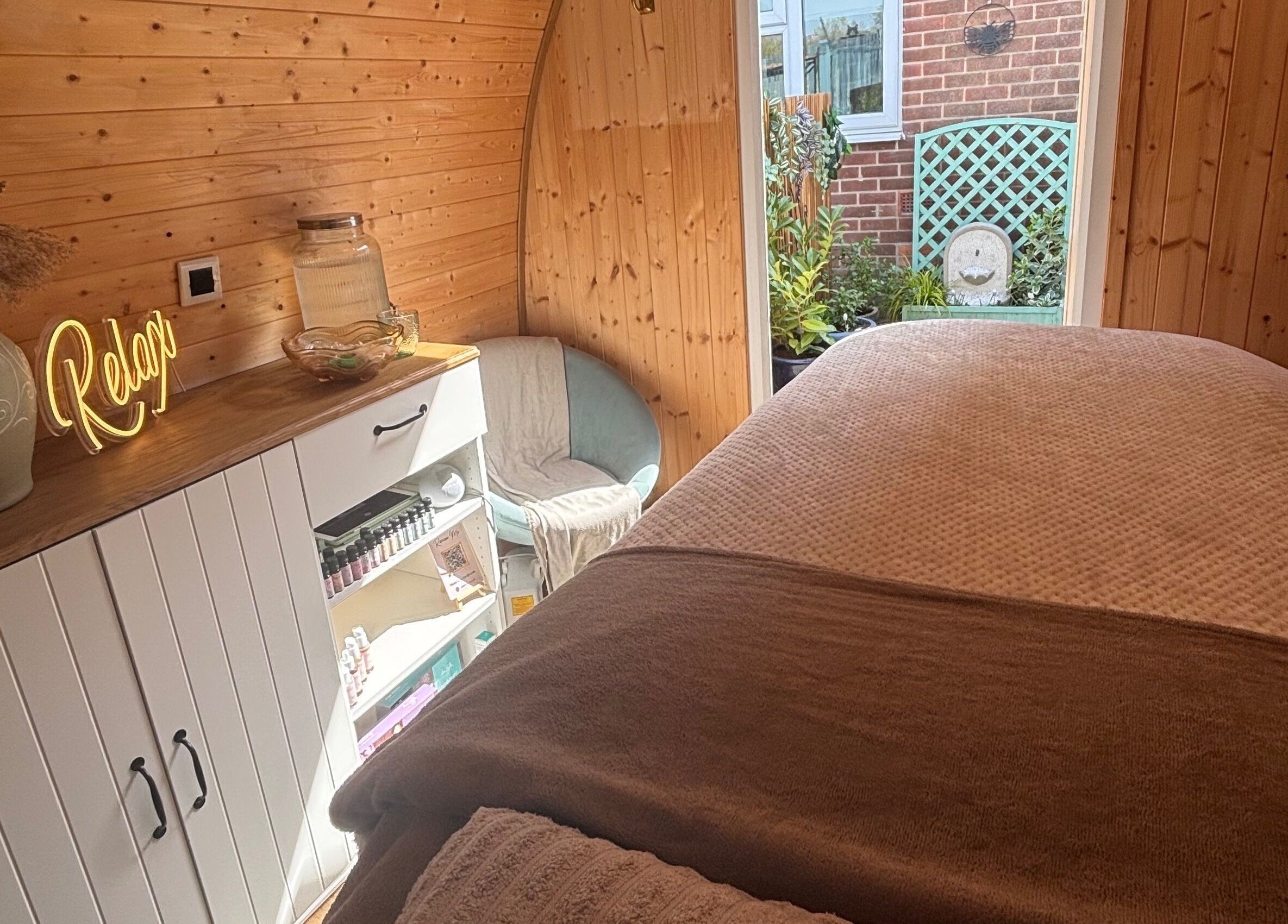 Relaxing spa room at Rhilax in Ilkeston, England, GB with warm wood panels and inviting decor.