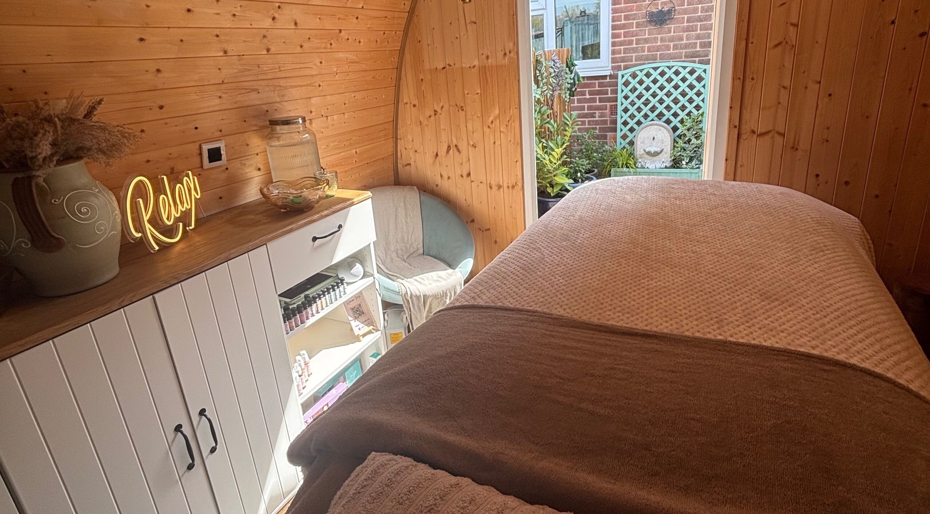 Relaxing spa room at Rhilax in Ilkeston, England, GB with warm wood panels and inviting decor.