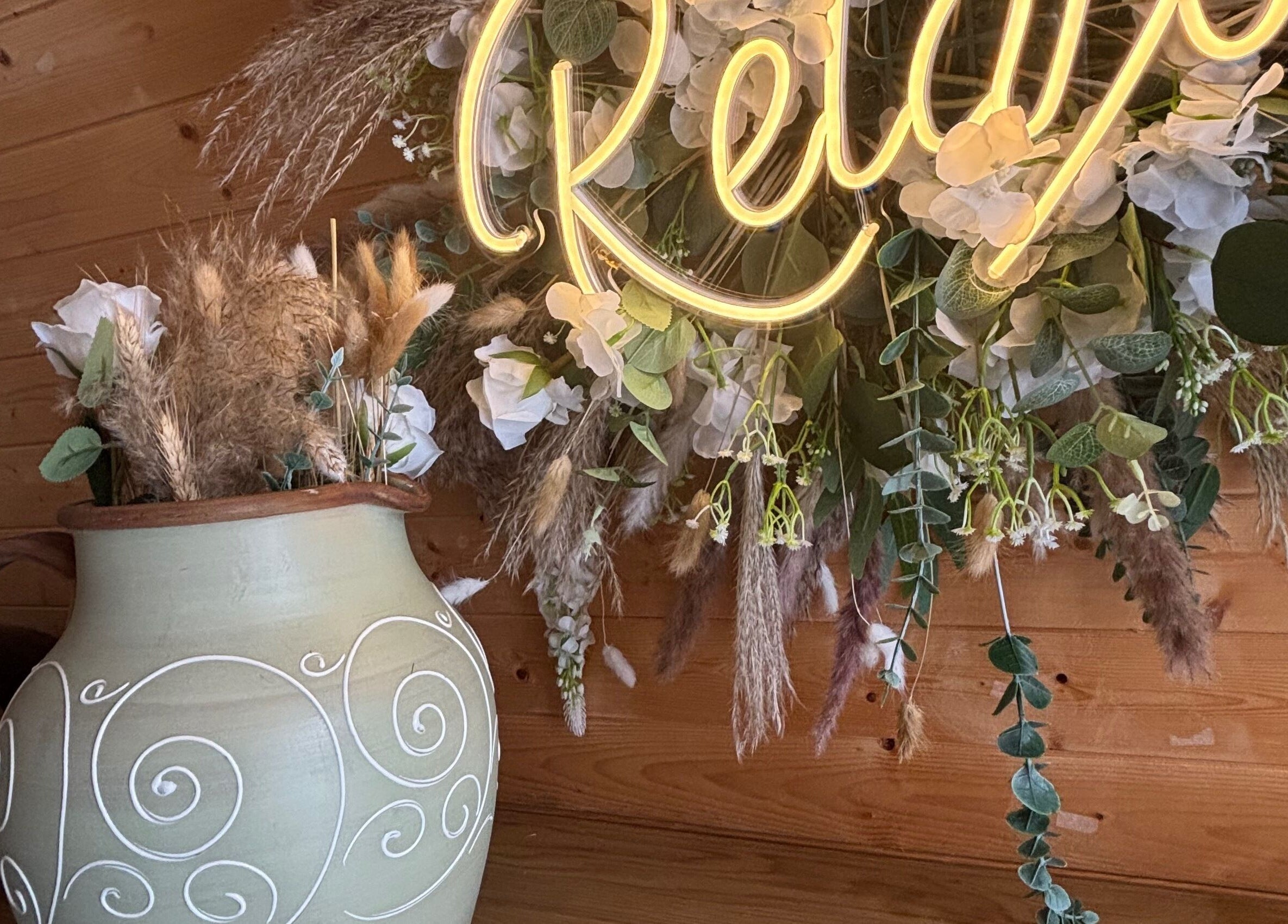 Elegant floral arrangement in a vase with 'Rhilax' sign at Rhilax, Ilkeston, England, GB.