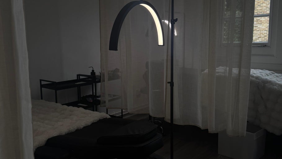 Cozy treatment room at Evara Amore, London, England, GB with a massage bed and soft lighting.