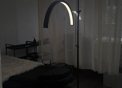Cozy treatment room at Evara Amore, London, England, GB with a massage bed and soft lighting.