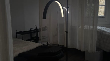 Cozy treatment room at Evara Amore, London, England, GB with a massage bed and soft lighting.