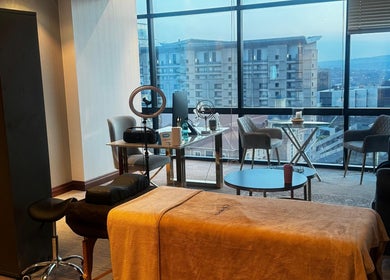Modern wellness suite at Aestheticsby.Yas in Sandton, Gauteng, ZA with massage bed and city view.