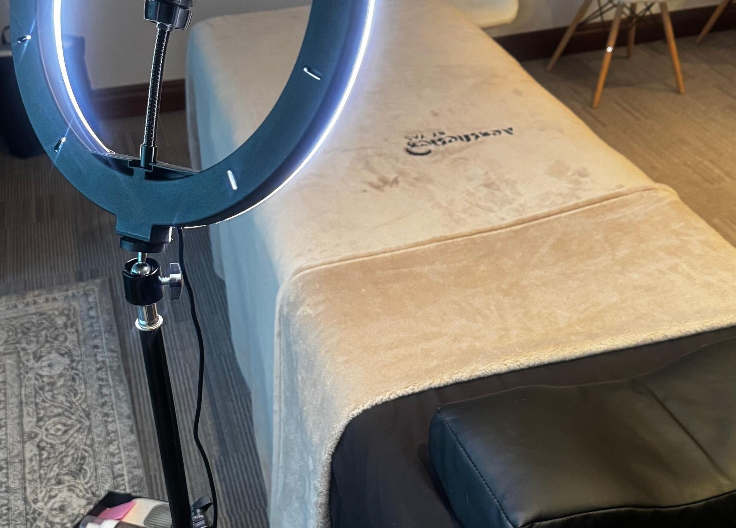 Cozy spa bed and ring light at Aestheticsby.Yas, Sandton, Gauteng, ZA for ultimate wellness experience.