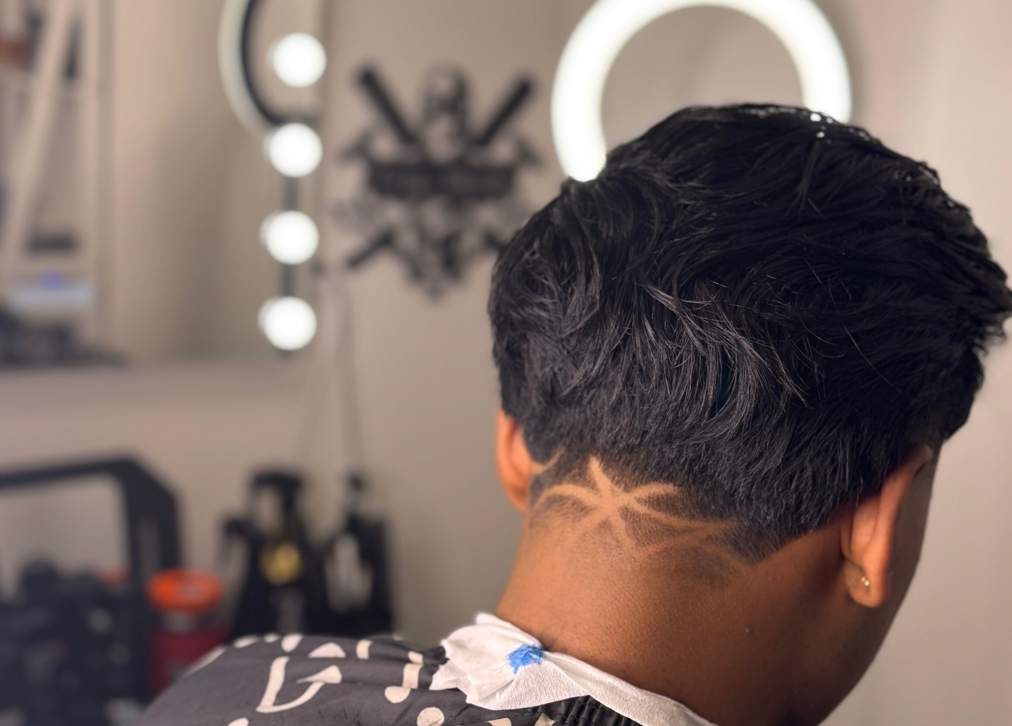 Artistic undercut hairstyle at Fergo Blends in Leppington, New South Wales, AU with ring light backdrop.