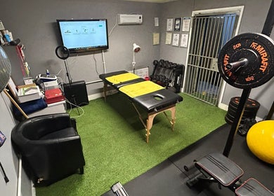 Therapy room at Physical Therapy & Rehab Ltd, Glynneath, Wales, with equipment for rehabilitation.