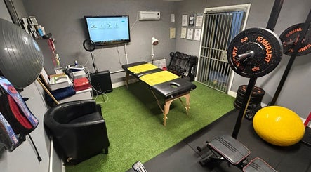 Therapy room at Physical Therapy & Rehab Ltd, Glynneath, Wales, with equipment for rehabilitation.