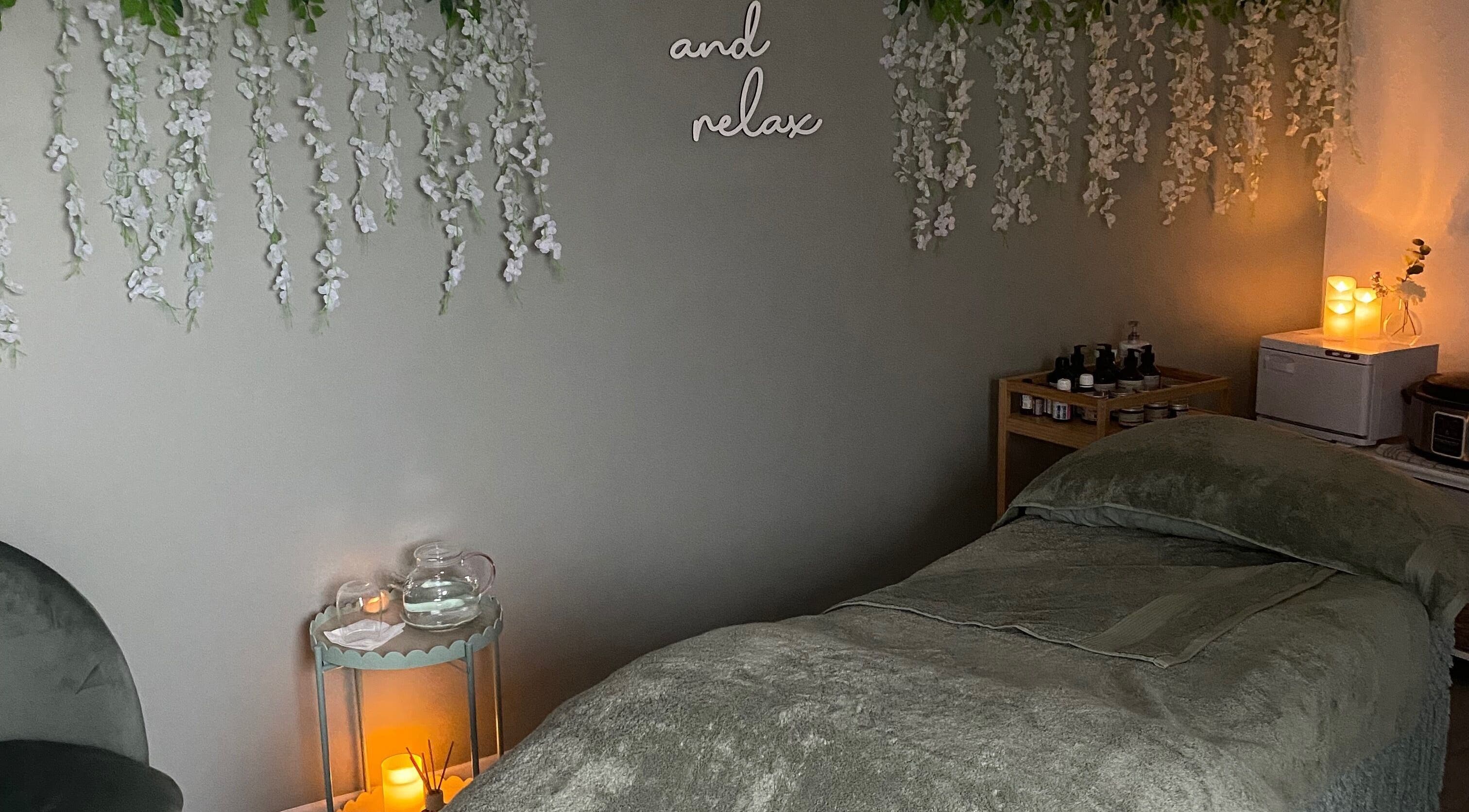 Peaceful massage room at Massage & Wellness Sanctuary, Winchburgh, Scotland, GB with relaxing lighting and decor.