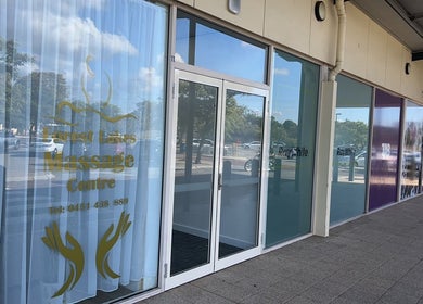 Entrance of Forest Lakes Massage Centre in Thornlie, Western Australia, AU, showcasing glass doors and signage.