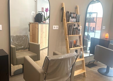 Interior de SV Saray Valdivia Beauty Hair Studio en Sabadell, Catalunya, ES, mostrando sillas y productos de belleza.