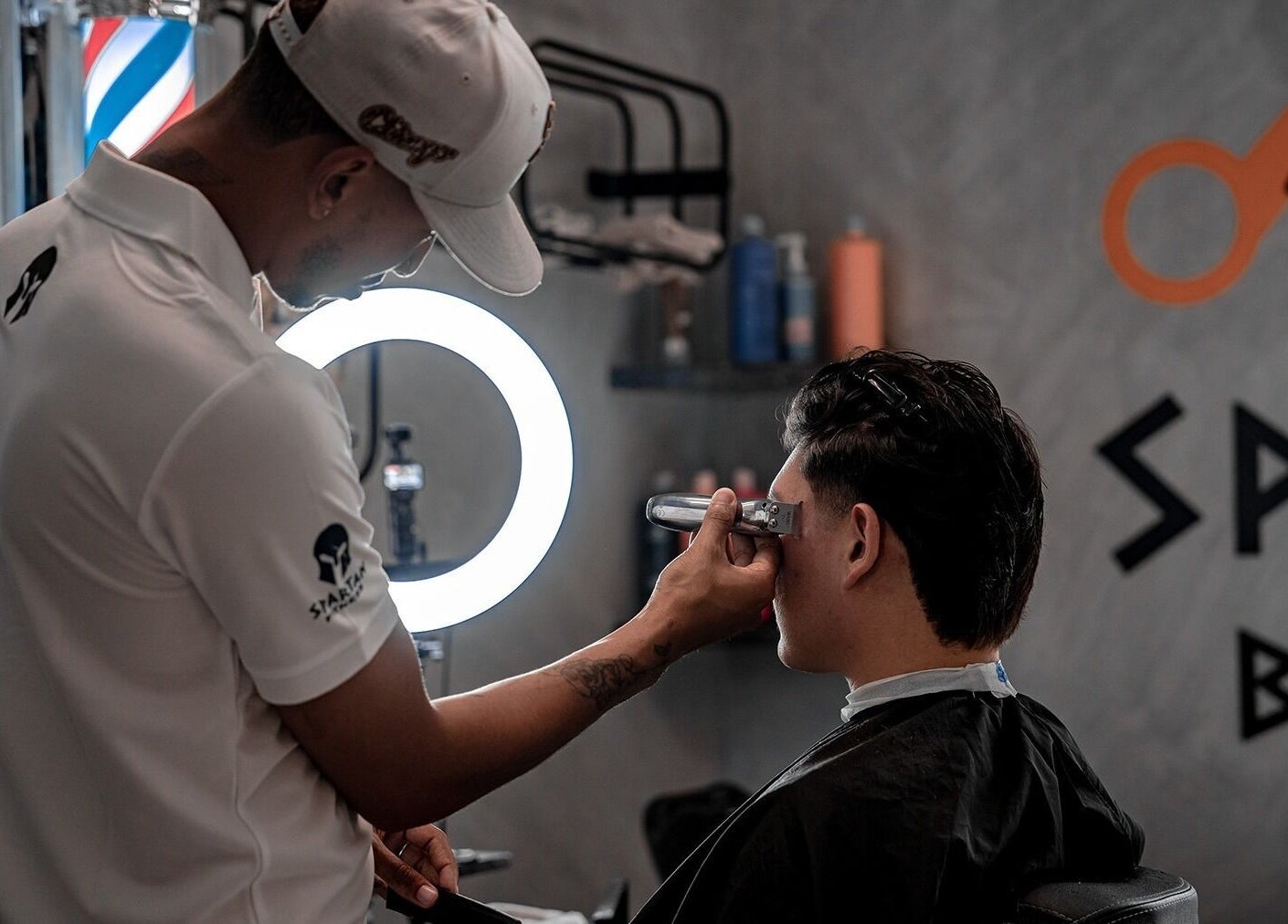 Barber at Spartan Barber WLL in Saar, Al-muḥāfaẓat Aš-šamālīyah, BH providing precise haircut services.