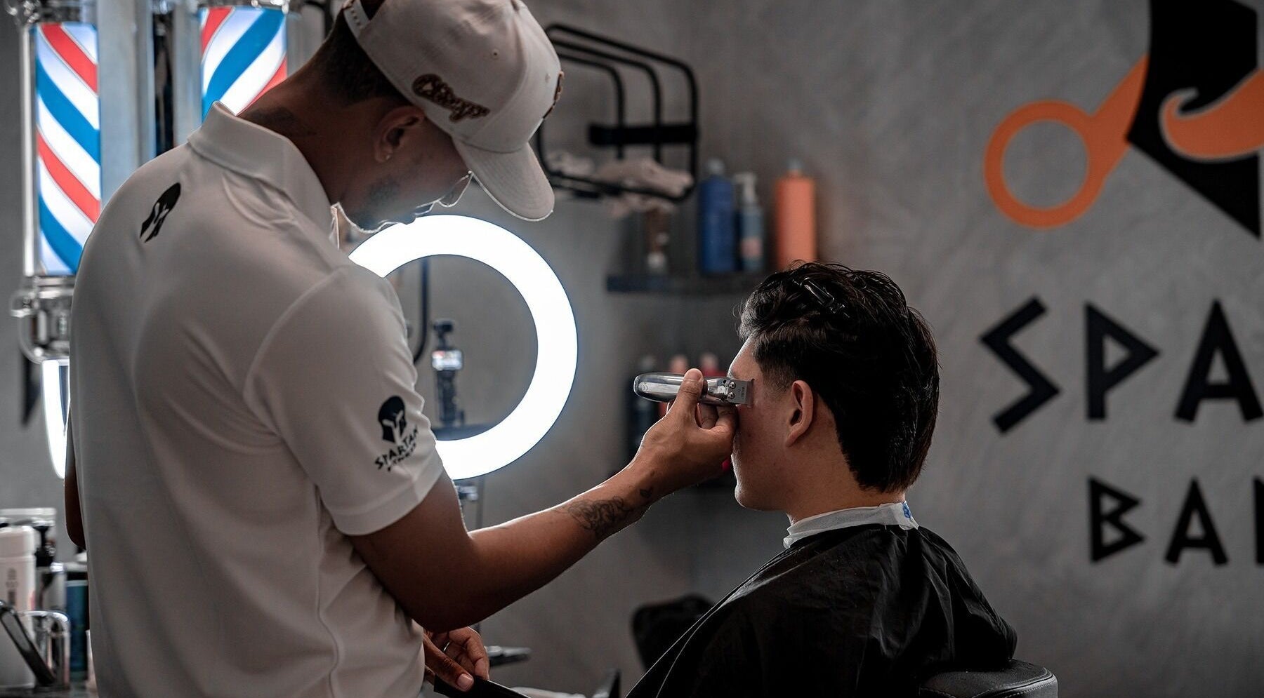 Barber at Spartan Barber WLL in Saar, Al-muḥāfaẓat Aš-šamālīyah, BH providing precise haircut services.