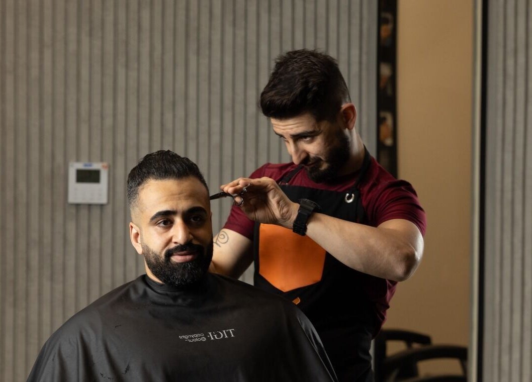 Barber crafting a haircut at Spartan Barber WLL, Saar, Al-muḥāfaẓat Aš-šamālīyah, BH.