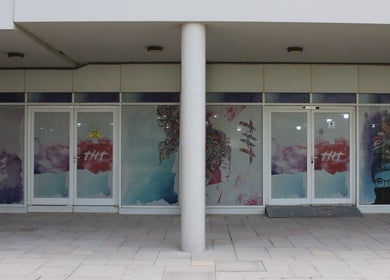Modern entrance of THT - That Hair Tho in Dubai, Dubai, AE with colorful artistic window designs.