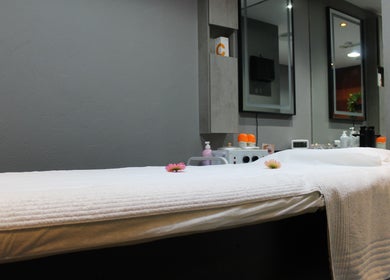 Relaxing treatment room at THT - That Hair Tho in Dubai, Dubai, AE, with a cozy massage bed.