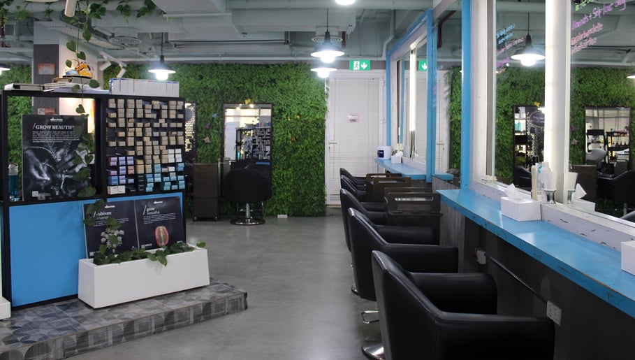 Modern interior of THT - That Hair Tho in Dubai, Dubai, AE with stylish seating and lush greenery.