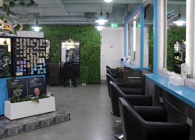 Modern interior of THT - That Hair Tho in Dubai, Dubai, AE with stylish seating and lush greenery.