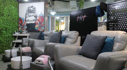 Stylish pedicure lounge at THT - That Hair Tho, Dubai, Dubai, AE with plush chairs and artistic decor.