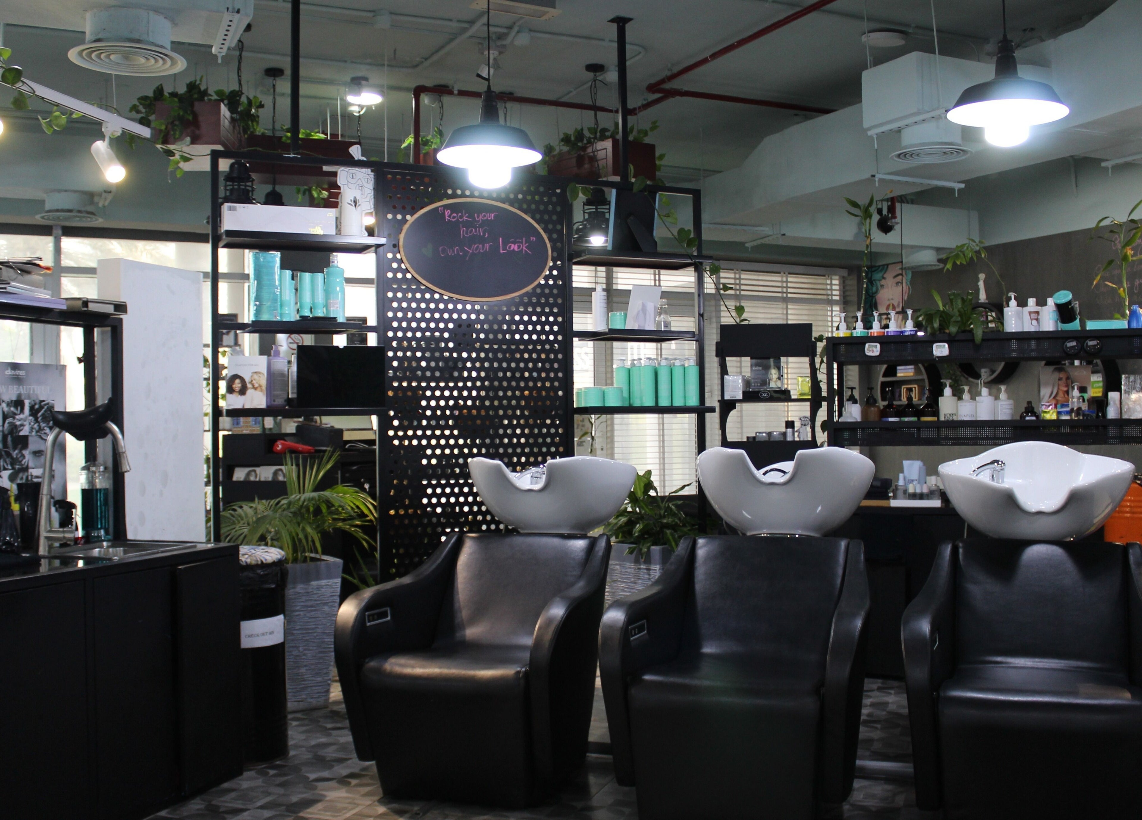 Modern salon wash stations at THT - That Hair Tho, Dubai, Dubai, AE with stylish decor and lighting.