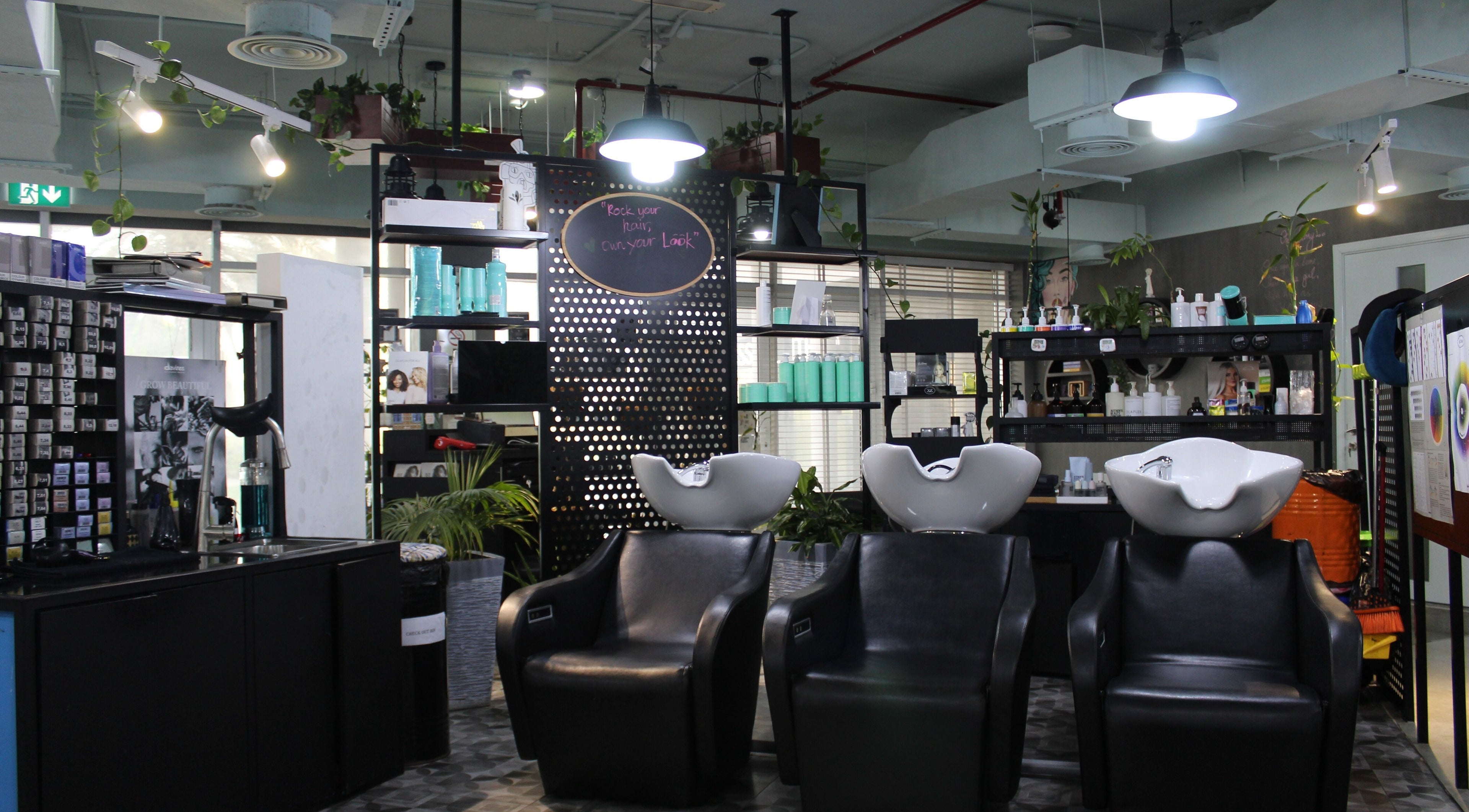 Modern salon wash stations at THT - That Hair Tho, Dubai, Dubai, AE with stylish decor and lighting.