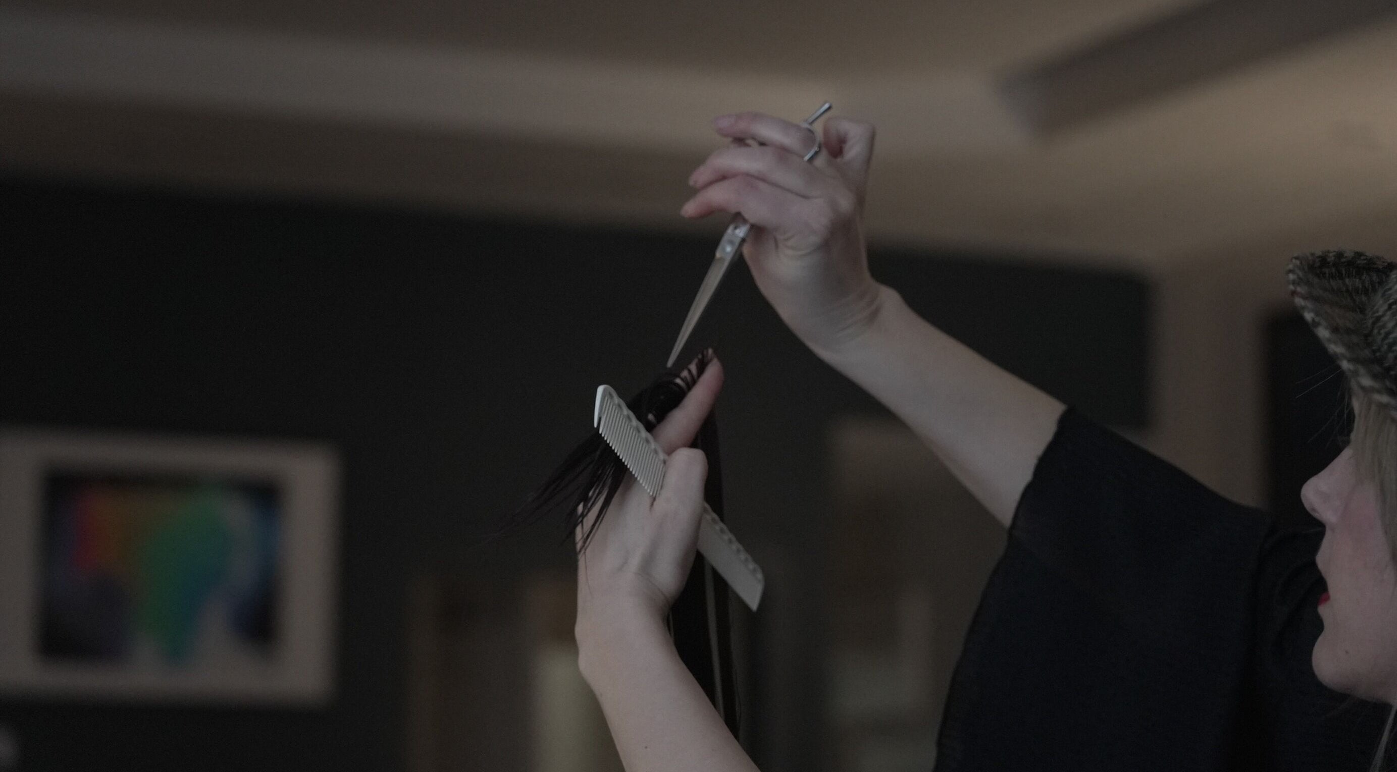 A stylist cutting hair at POP West Norwood, London, England, GB, showcasing trendy salon services.