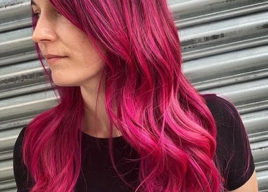Bright pink hair styled at POP West Norwood, London, England, GB against a metal backdrop.