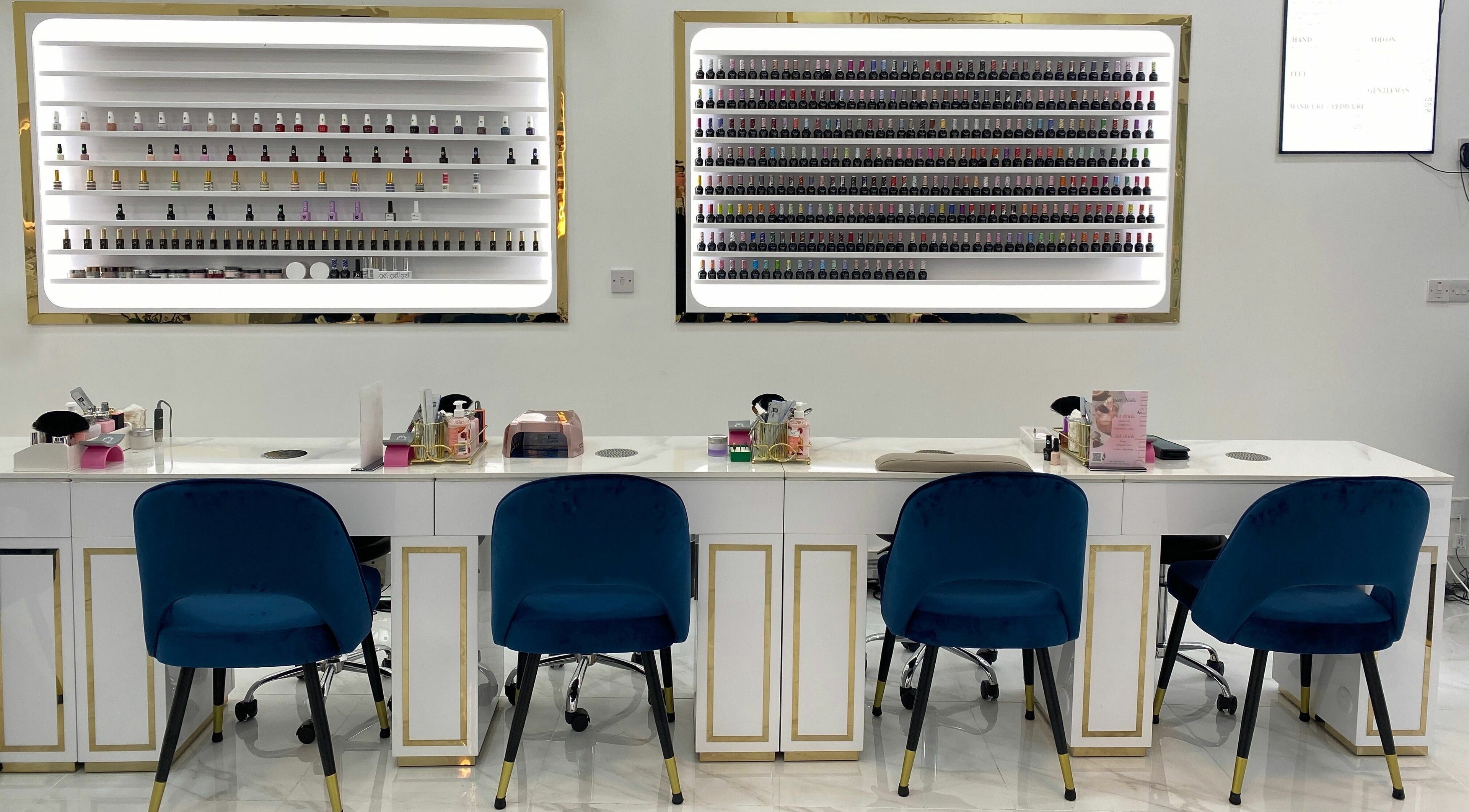 Interior of Queen Nails in London, England, GB showcasing chic nail bar with elegant chairs and polish displays.
