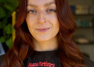 Customer with styled hair at Mane Artistry By Jay, Hertfordshire, GB, showcasing vibrant salon expertise.