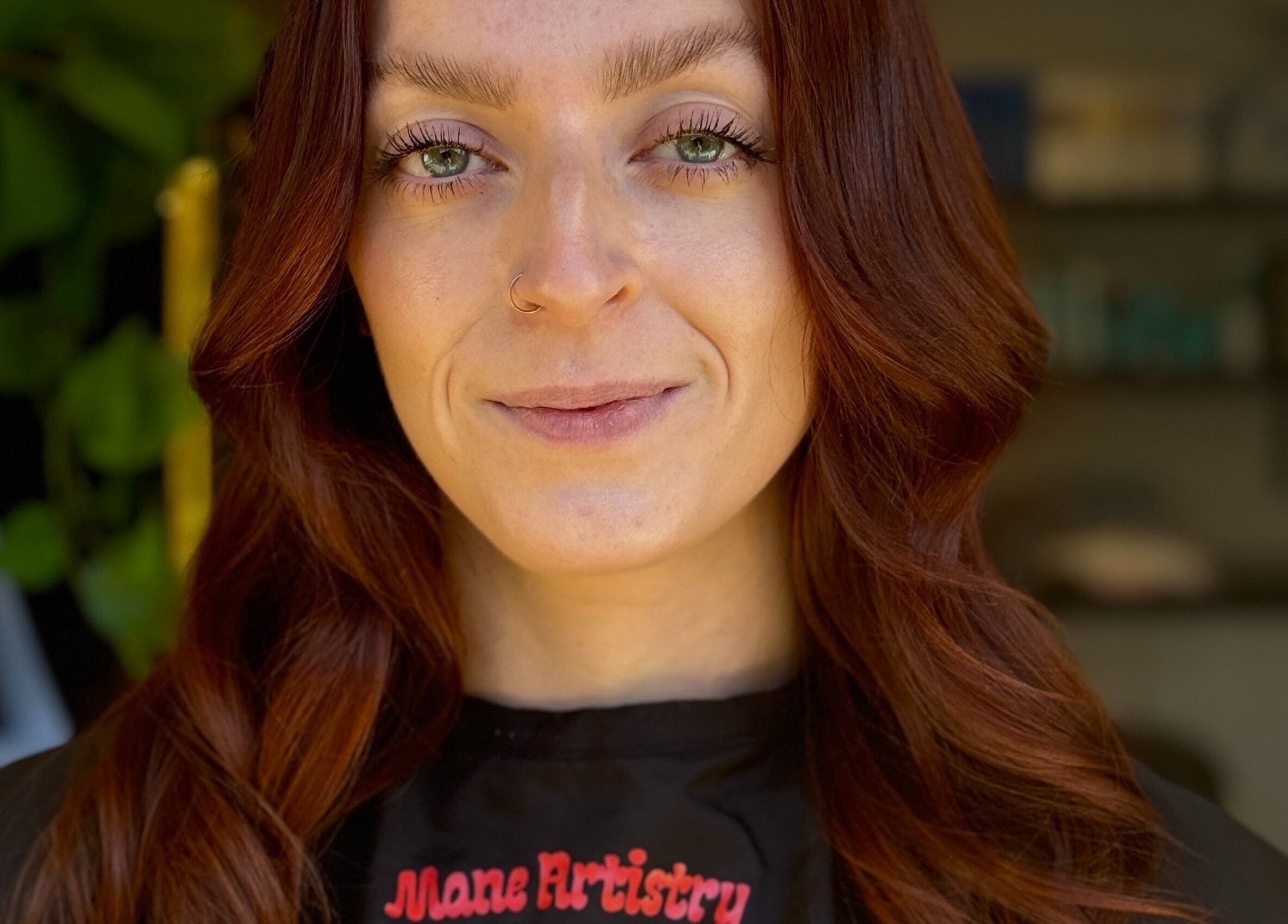 Customer with styled hair at Mane Artistry By Jay, Hertfordshire, GB, showcasing vibrant salon expertise.