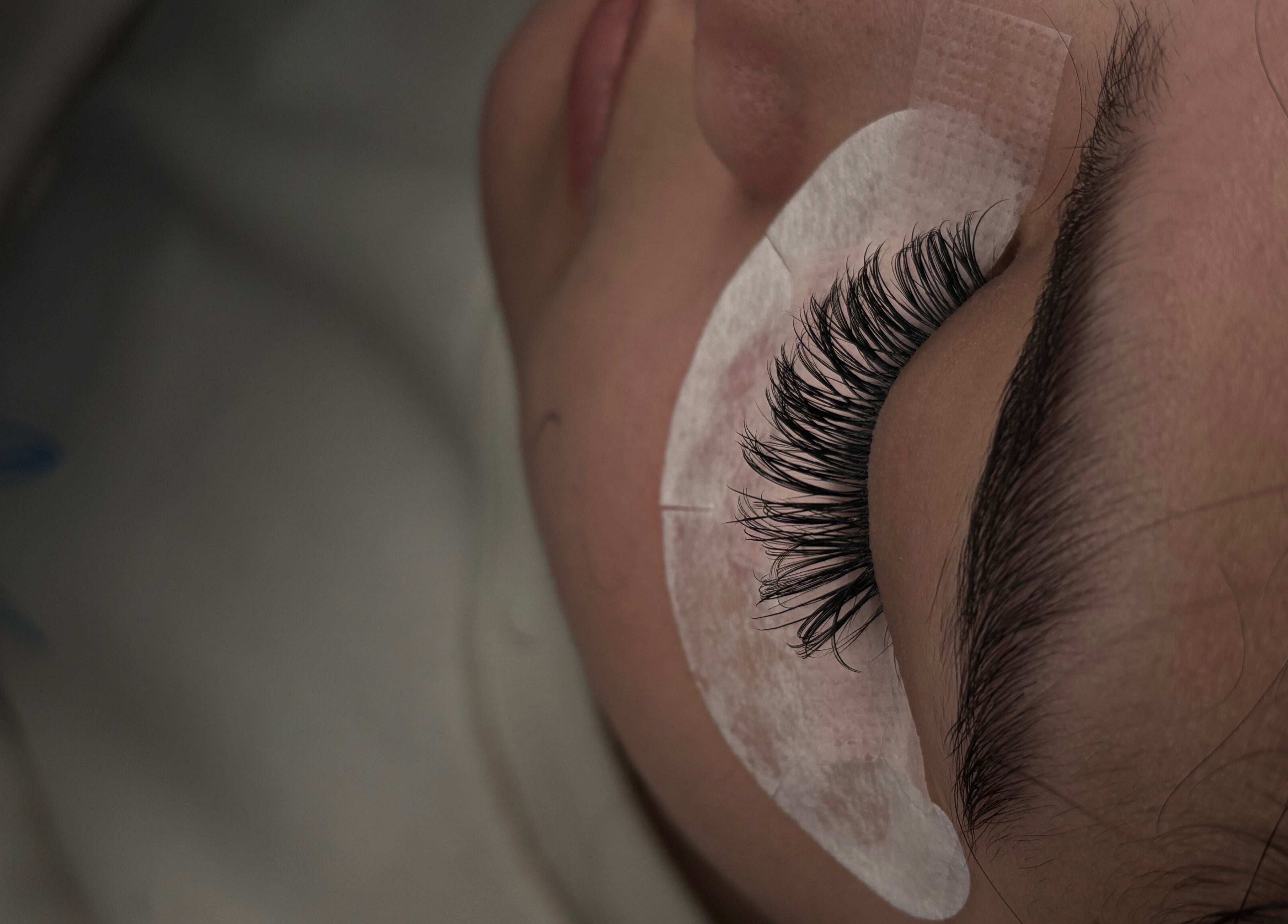 Eyelash extension applied at Winks and Minks, Elkhart, Indiana, US, showcasing precise beauty techniques.