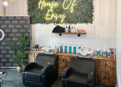 House Of Envy Longford salon interior in Gloucester, England, showcasing styling chairs and vibrant decor.