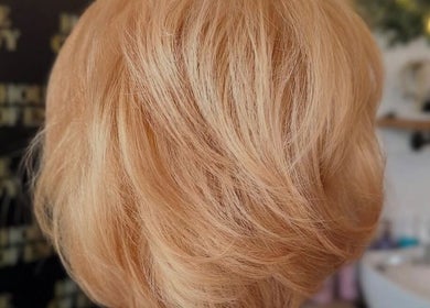 Stylish blond hairstyle at House Of Envy Longford in Gloucester, England, GB.