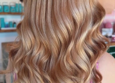 Golden blonde waves styled at House Of Envy Longford, Gloucester, England, GB. Sleek, shiny hair transformation.