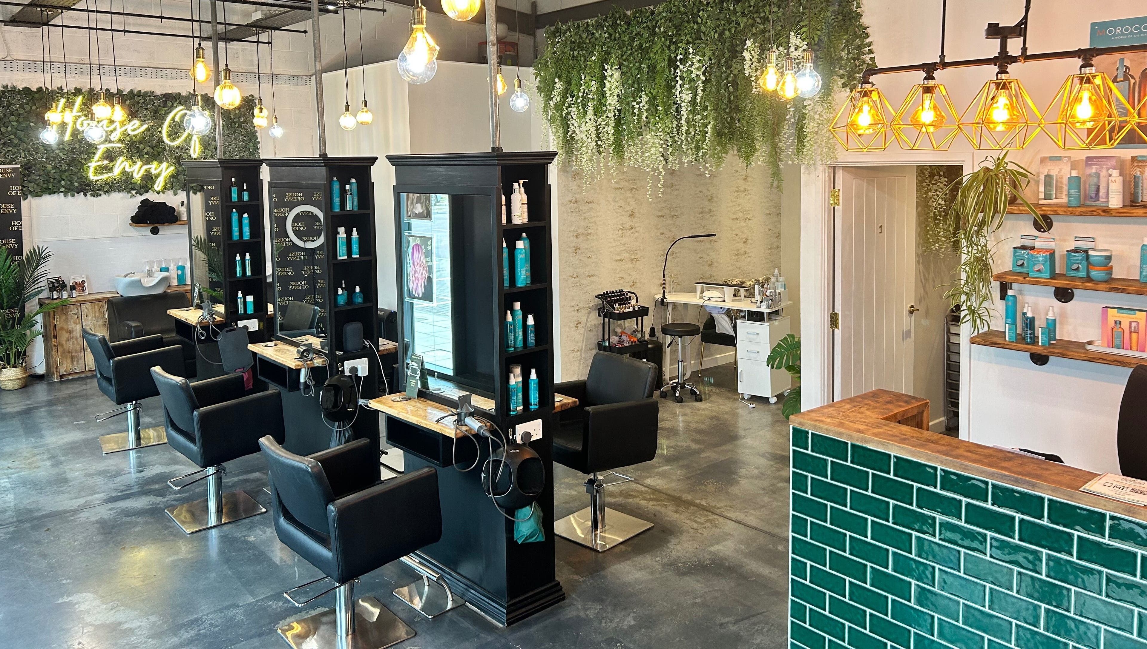 Stylish interior of House Of Envy Longford salon in Gloucester, England, GB with modern decor and seating.
