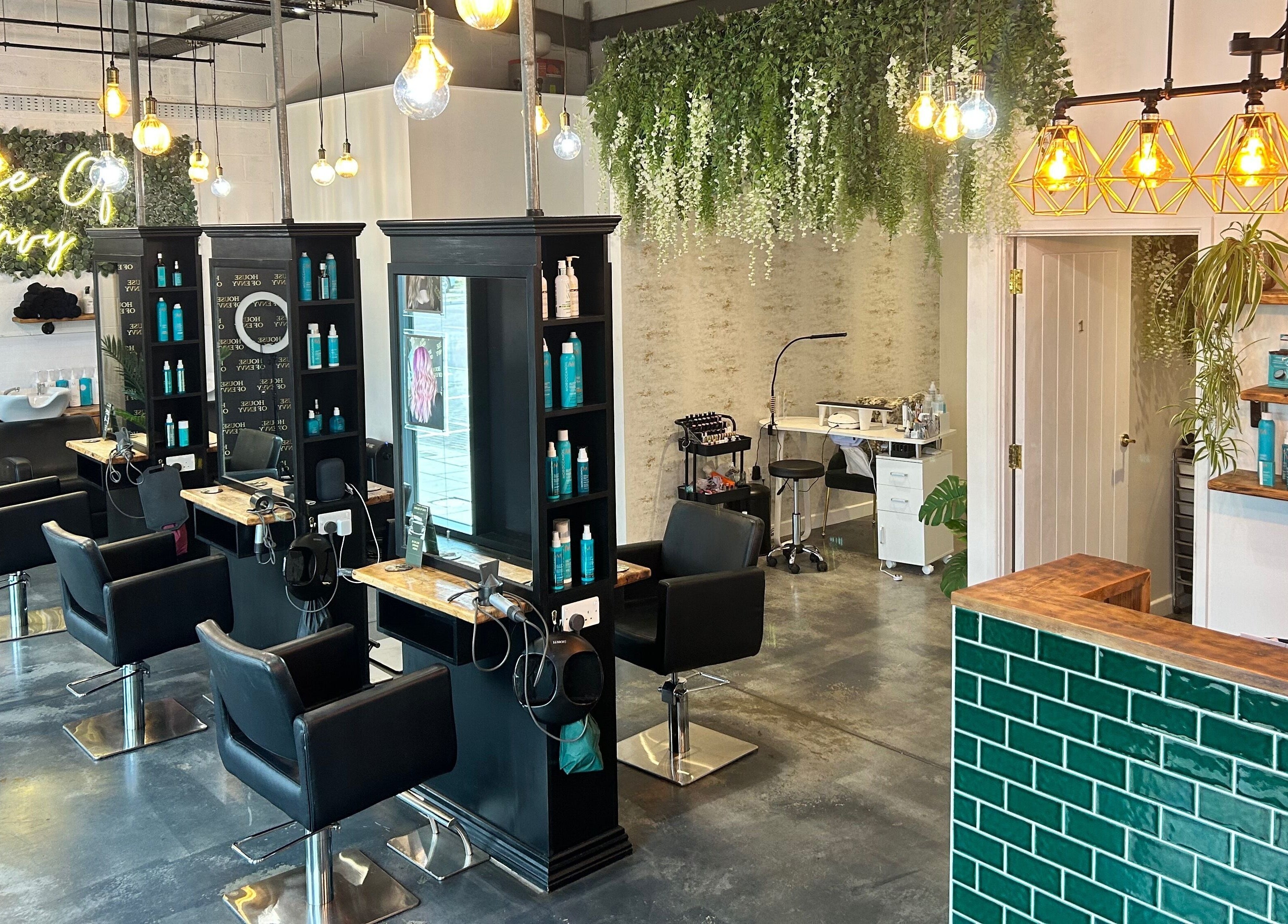 Stylish interior of House Of Envy Longford salon in Gloucester, England, GB with modern decor and seating.