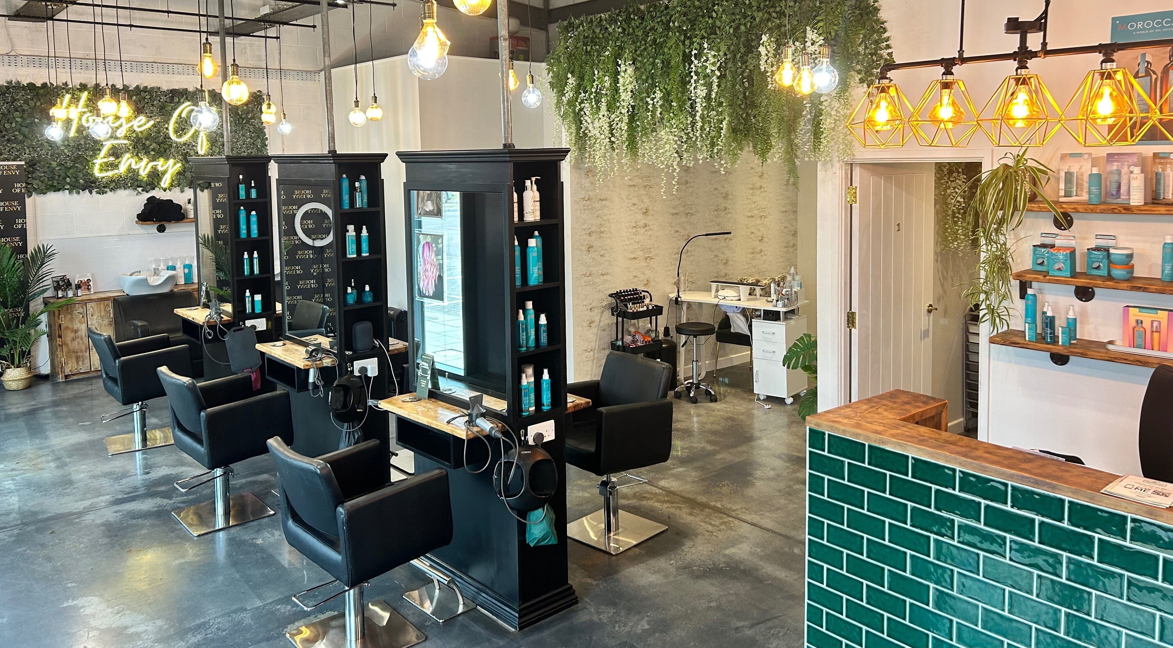 Stylish interior of House Of Envy Longford salon in Gloucester, England, GB with modern decor and seating.