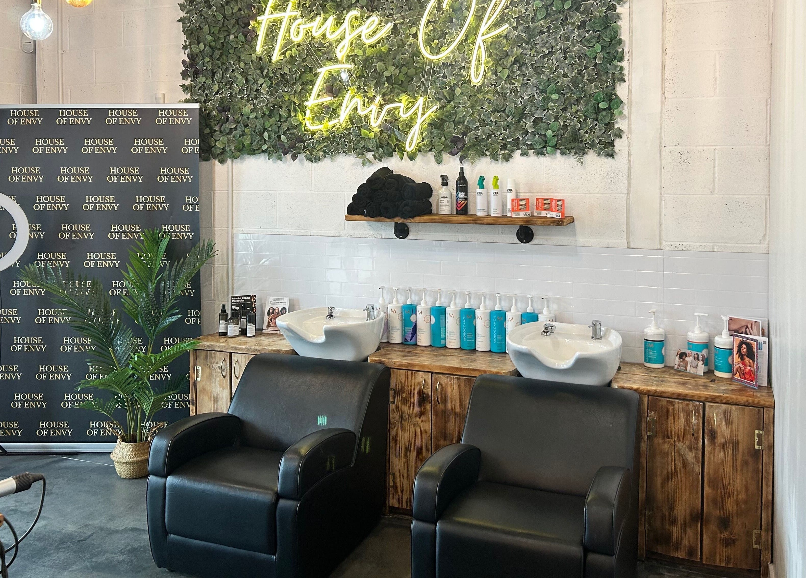 Two styling chairs at House Of Envy Longford, Gloucester, England, GB with elegant decor and product display.