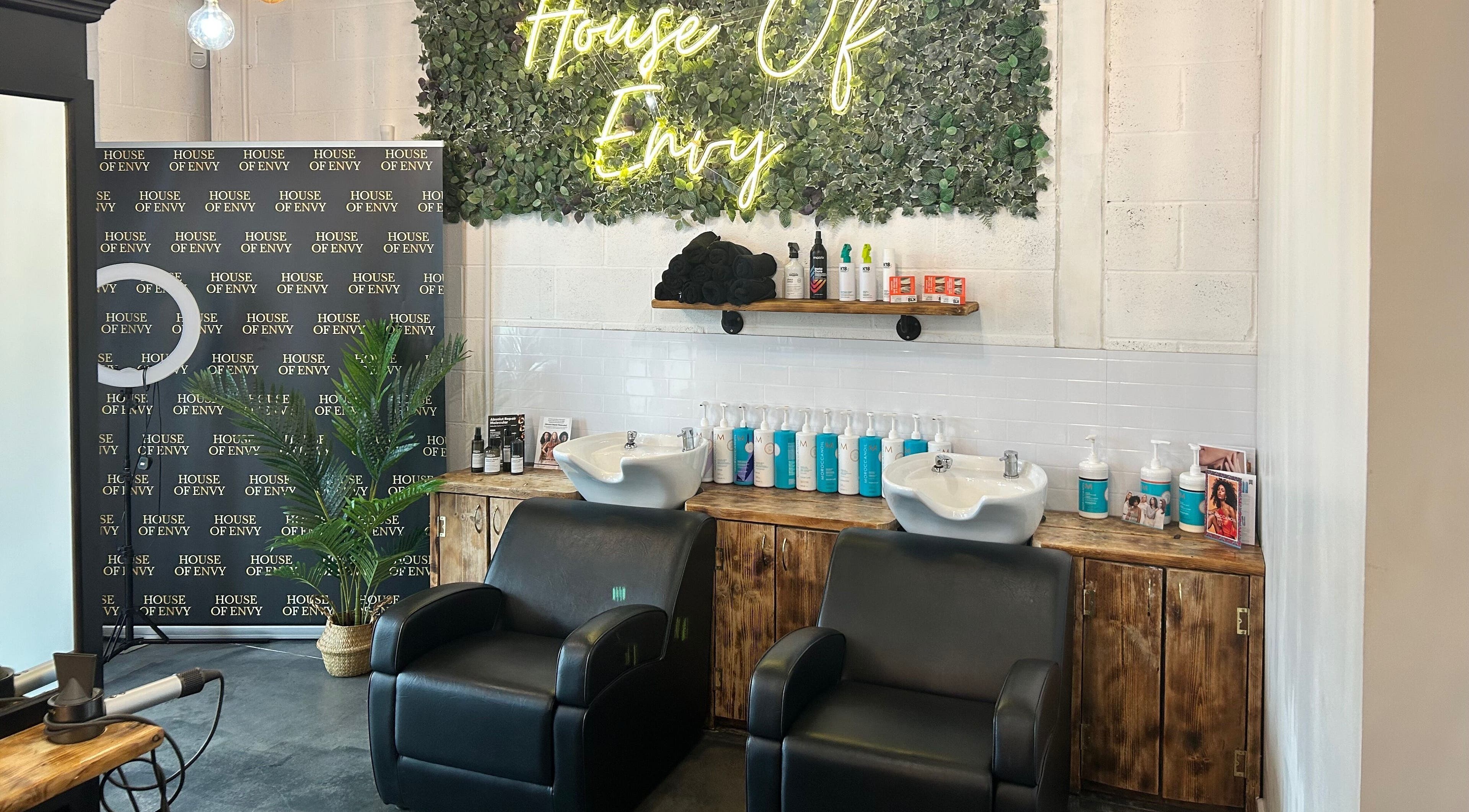 Two styling chairs at House Of Envy Longford, Gloucester, England, GB with elegant decor and product display.