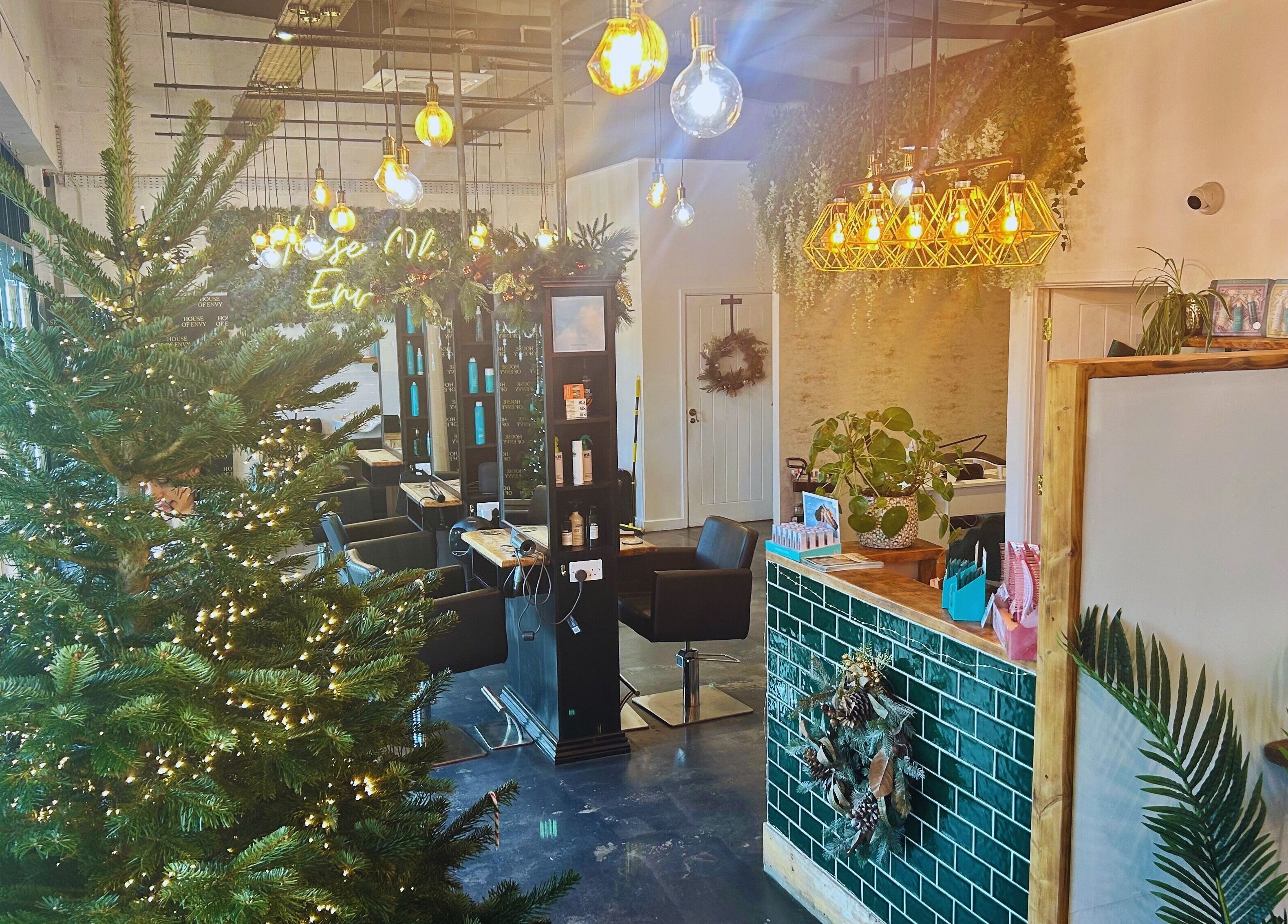 Festive and elegant interior of House Of Envy Longford, Gloucester, England, GB with seasonal decor and chic lighting.