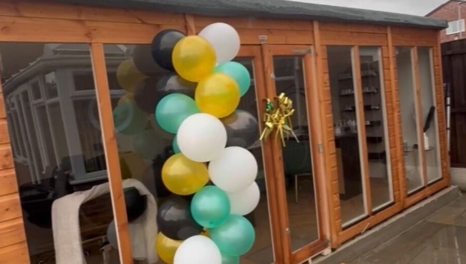 Elegant balloon display at Wings of Beauty, Leeds, England, GB, enhancing the wooden entrance.