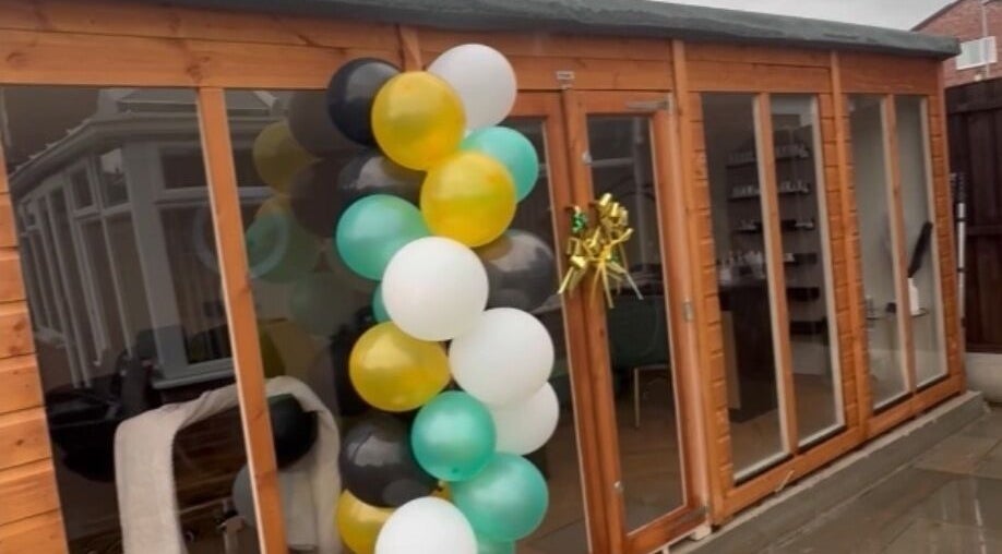 Elegant balloon display at Wings of Beauty, Leeds, England, GB, enhancing the wooden entrance.
