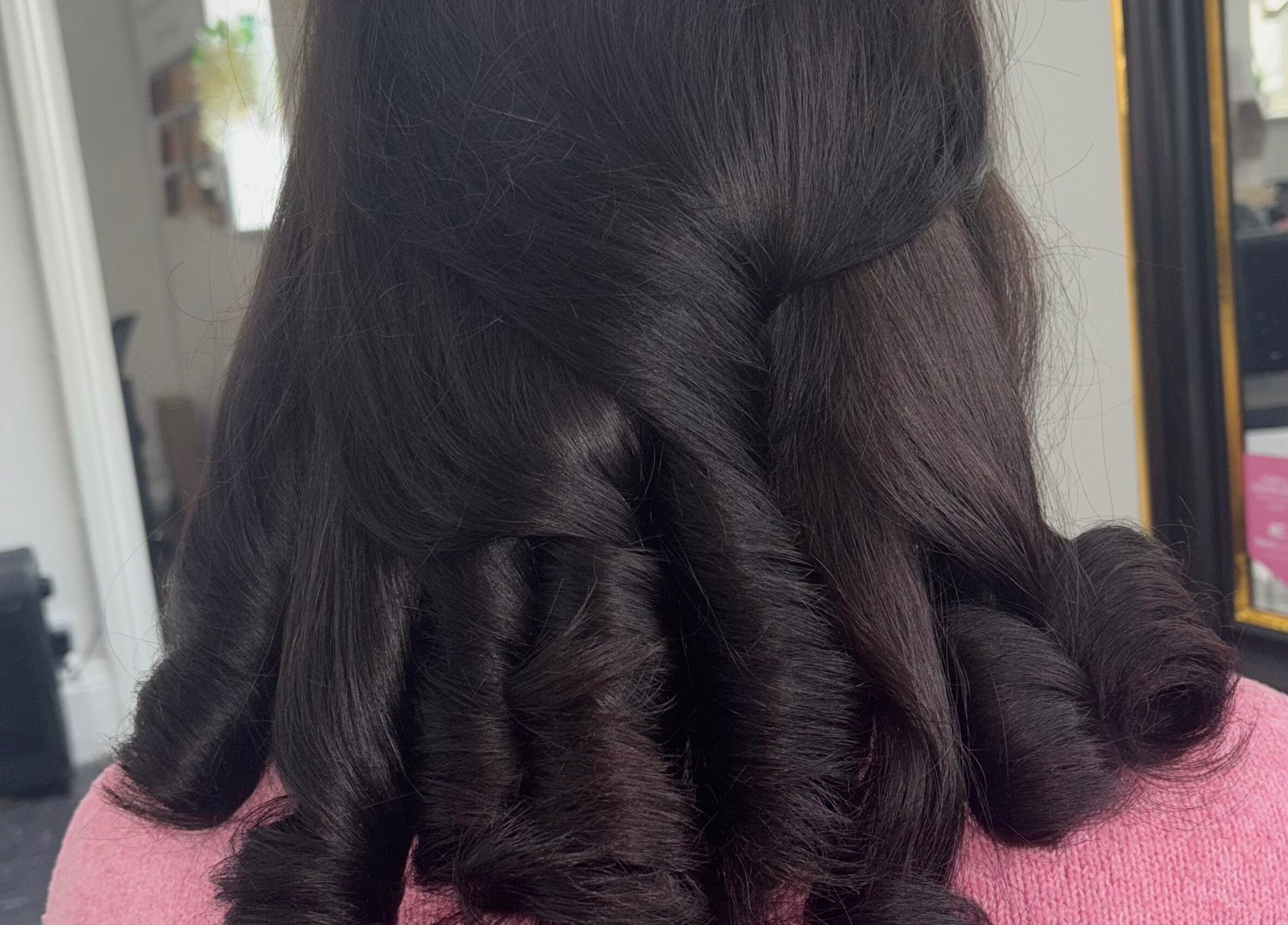 Styled curls at Hair by Lottie, Weston-super-Mare, England, GB in a sleek salon environment.